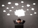 Businessman sitting with cloud technology above his head